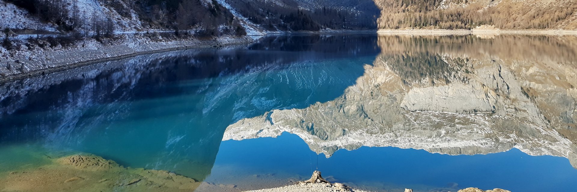 Alpine lake mirroring snow-dusted peaks