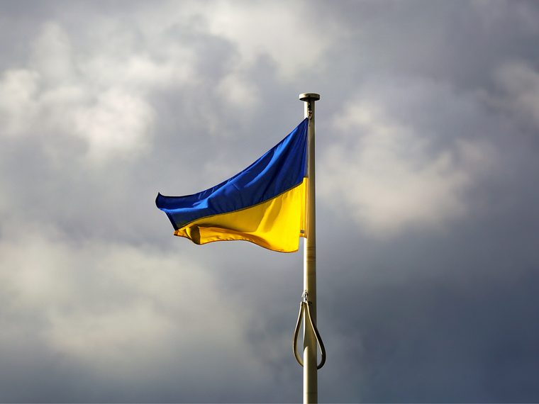Ukrainian flag flying against a stormy sky